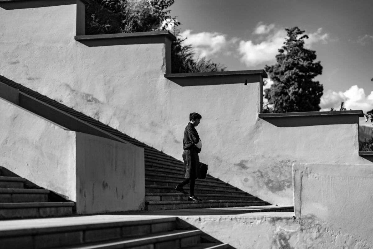 black and white image of person on urban steps