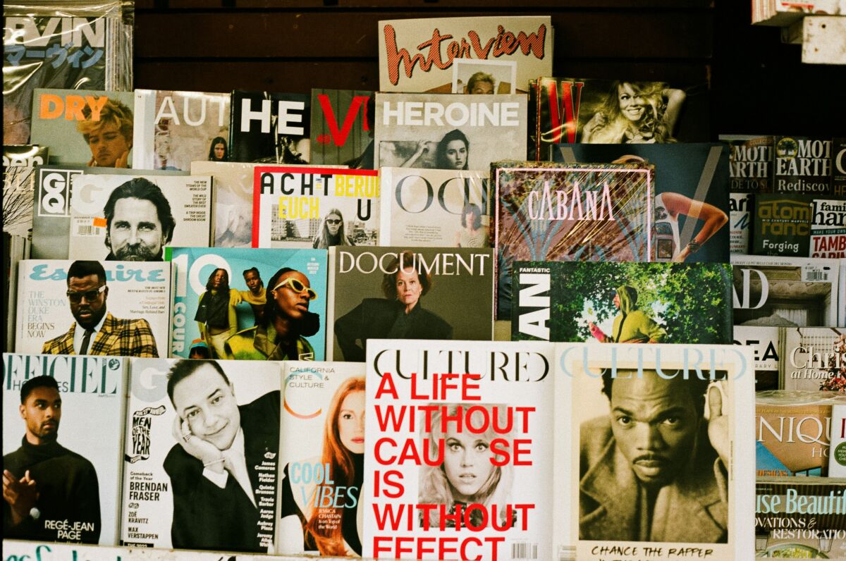A bunch of magazines are stacked on a wall