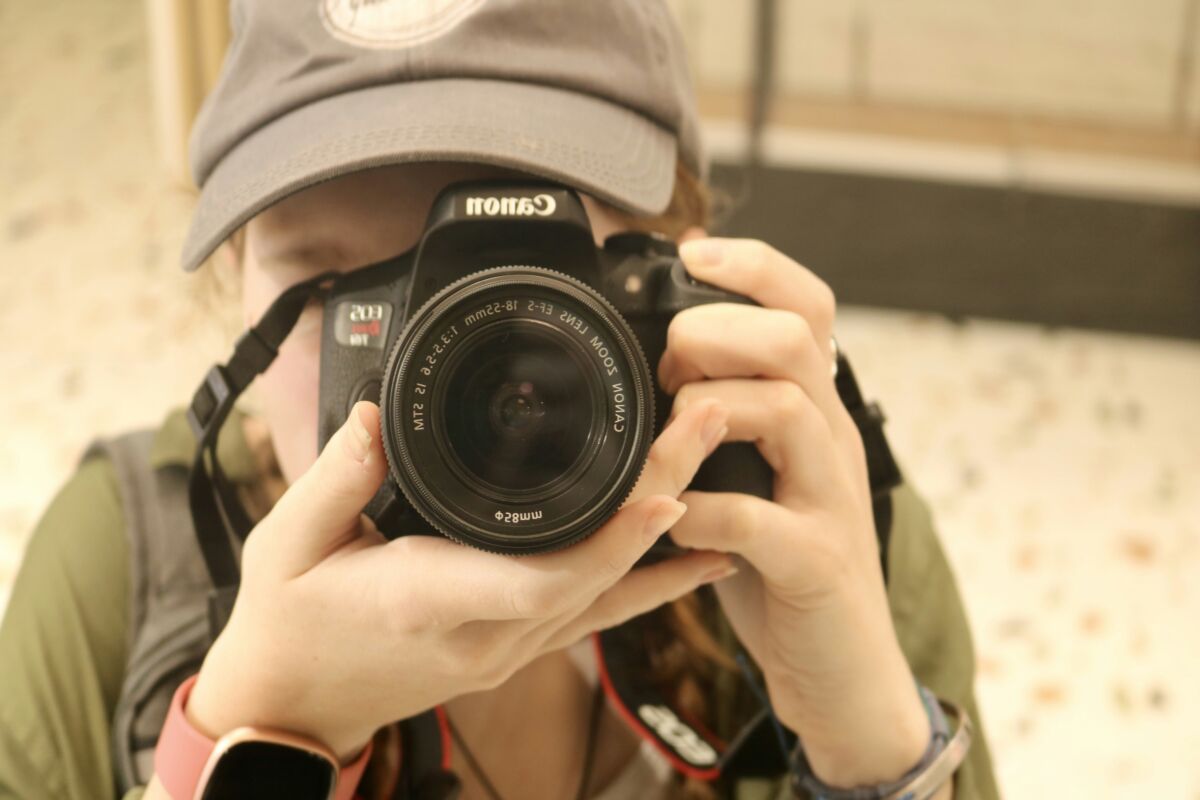 A person is taking a picture with a camera.